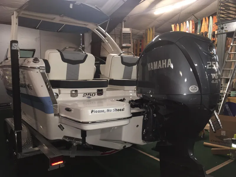 Slide: The Image of 2023 Chaparral 250 OSX boat with Yamaha engine in indoor storage. - 3