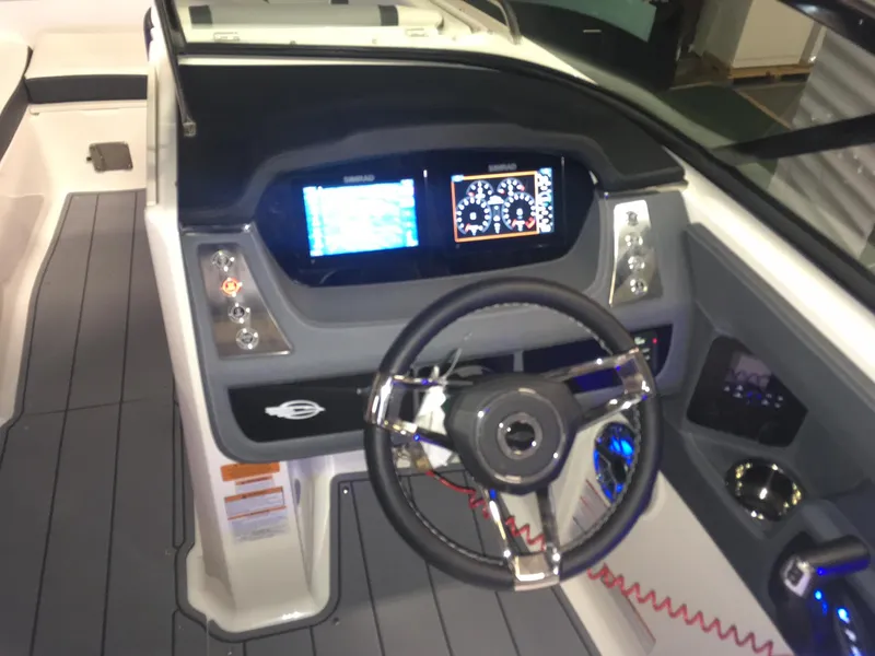 Slide: The Image of 2023 Chaparral 250 OSX boat dashboard with modern controls and steering wheel. - 4
