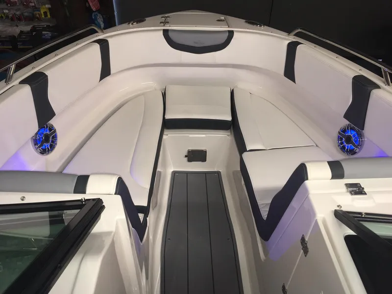 Slide: The Image of 2023 Chaparral 250 OSX boat interior with cushioned seating and speakers. - 8