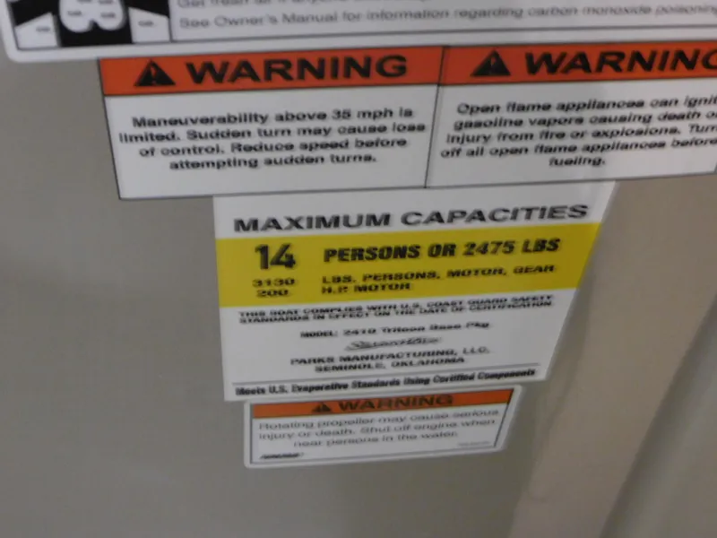 Slide: The Image of 2023 Silver Wave 2410 SW5 L capacity and warning labels, 14 persons or 2475 lbs maximum. - 11