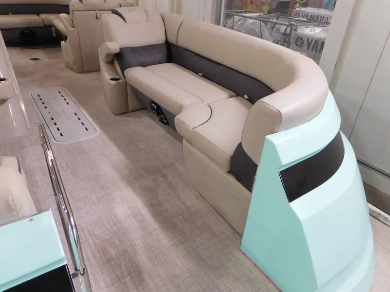 Slide: The Image of 2023 Silver Wave 2410 SW5 L pontoon boat interior with beige seating and light blue accents. - 4