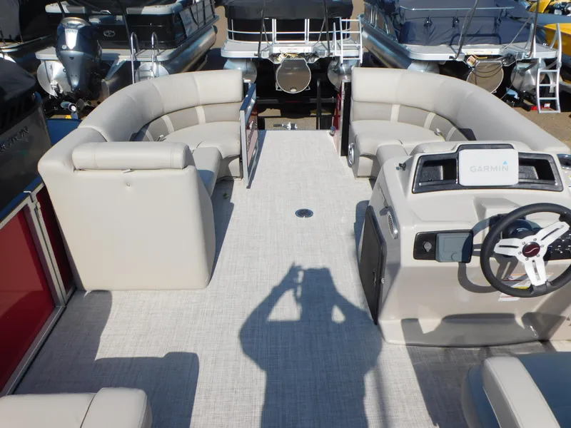 Slide: The Image of 2023 Silver Wave 2210 SW3 RLP pontoon boat interior with beige seating and Garmin navigation. - 3