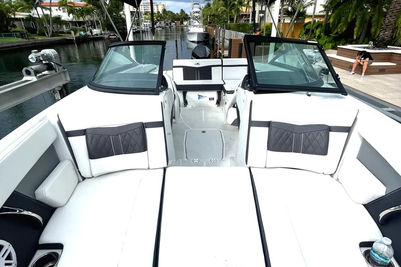 Slide: The Image of 2022 Monterey M225 boat with spacious seating and modern design docked in a canal. - 15
