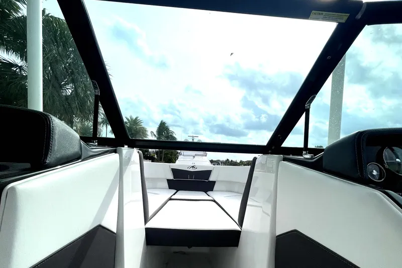 Slide: The Image of 2022 Monterey M225 boat interior with sleek white and black seating. - 17