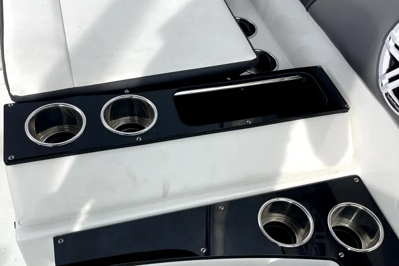 Slide: The Image of 2022 Monterey M225 boat interior with cup holders and seating. - 19