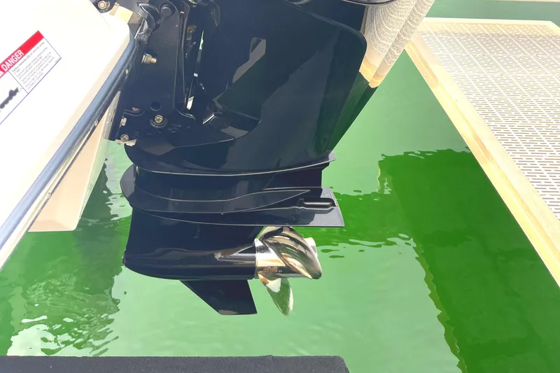 Slide: The Image of 2022 Monterey M225 boat propeller in green water at dock. - 30