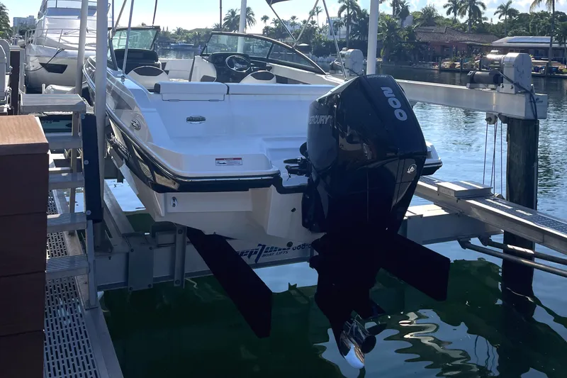 Slide: The Image of 2022 Monterey M225 boat on a lift at a marina. - 5