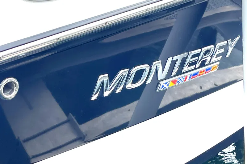 Slide: The Image of 2022 Monterey M225 boat with logo and nautical flags - 7