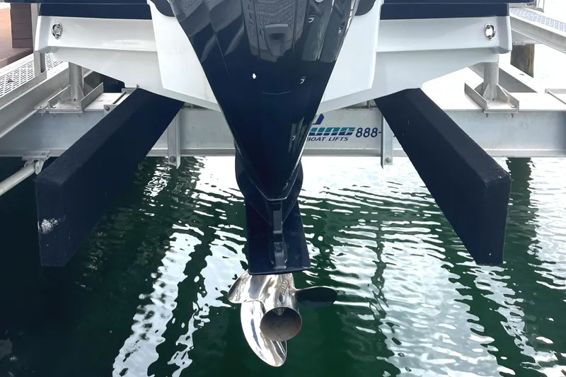 Slide: The Image of 2022 Monterey M225 boat propeller and lift system over water. - 8
