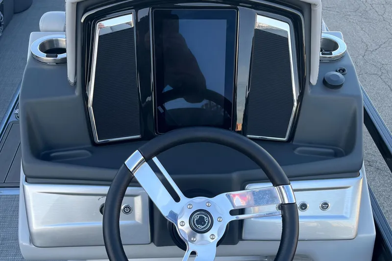 Slide: The Image of 2023 Regency 250 LE3 boat dashboard with steering wheel and control panel. - 10