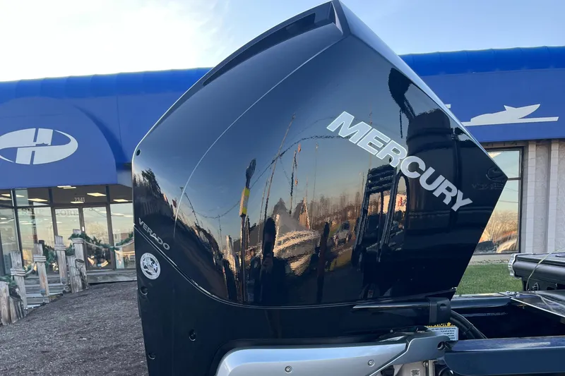 Slide: The Image of 2023 Regency 250 LE3 with Mercury outboard motor at dealership. - 11