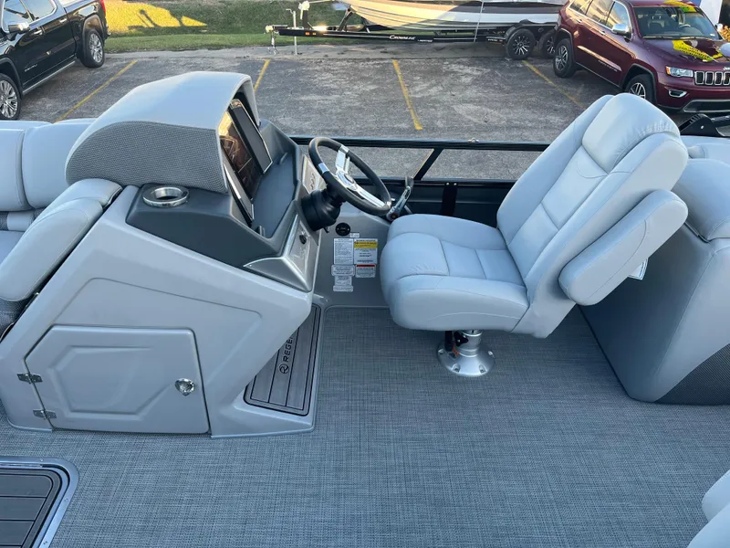 Slide: The Image of 2023 Regency 250 LE3 boat interior with captain's chair and helm station. - 4