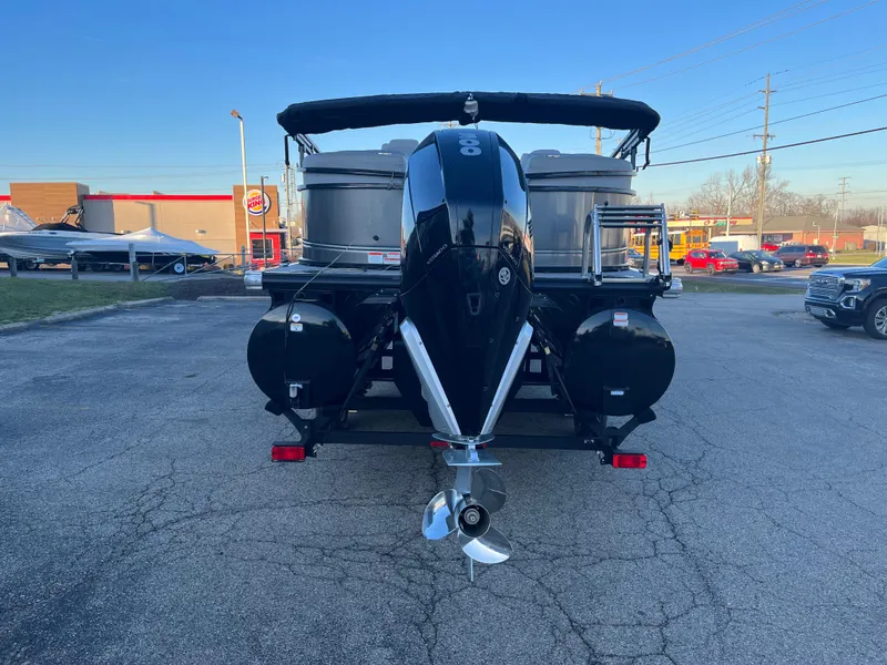 Slide: The Image of 2023 Regency 250 LE3 pontoon boat with outboard motor, rear view. - 7