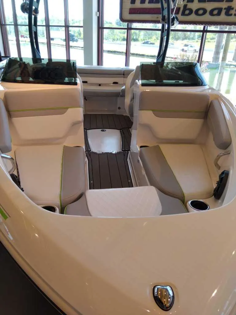 Slide: The Image of 2023 Tahoe 210 Si Limited boat interior with seating and cup holders. - 3