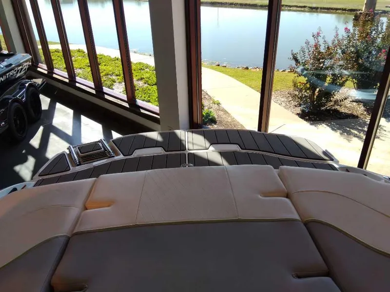 Slide: The Image of 2023 Tahoe 210 Si Limited boat interior with lake view through large windows. - 7