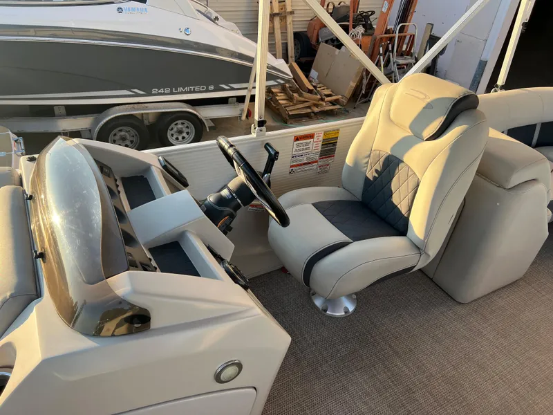 Slide: The Image of 2019 Bennington 22 SSRX boat interior with captain's chair and steering console. - 10