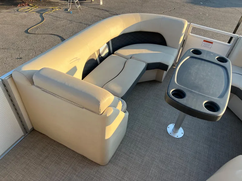 Slide: The Image of 2019 Bennington 22 SSRX boat interior with beige seating and table. - 15