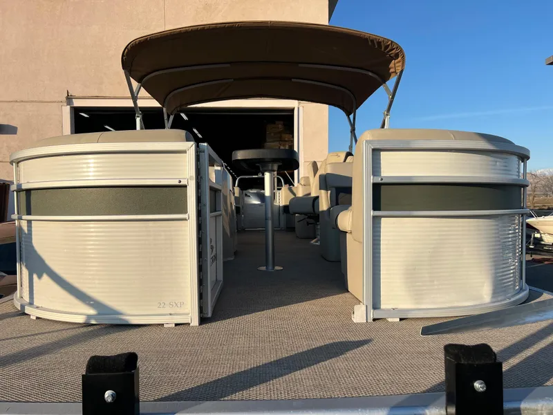 Slide: The Image of 2019 Bennington 22 SSRX pontoon boat with canopy in a docked position. - 3