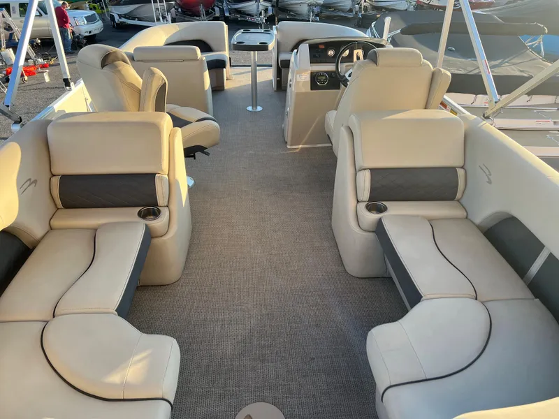 Slide: The Image of 2019 Bennington 22 SSRX pontoon boat interior with beige seating and spacious layout. - 8