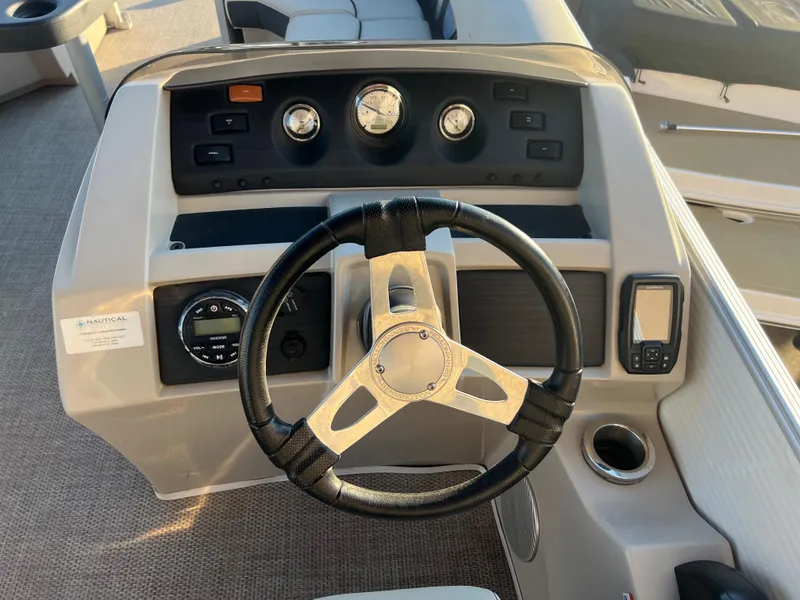 Slide: The Image of 2019 Bennington 22 SSRX boat dashboard with steering wheel and control panel. - 9