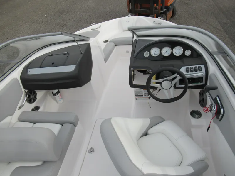 Slide: The Image of 2019 Regal 1900 ES Bowrider boat interior with steering wheel and seating. - 11