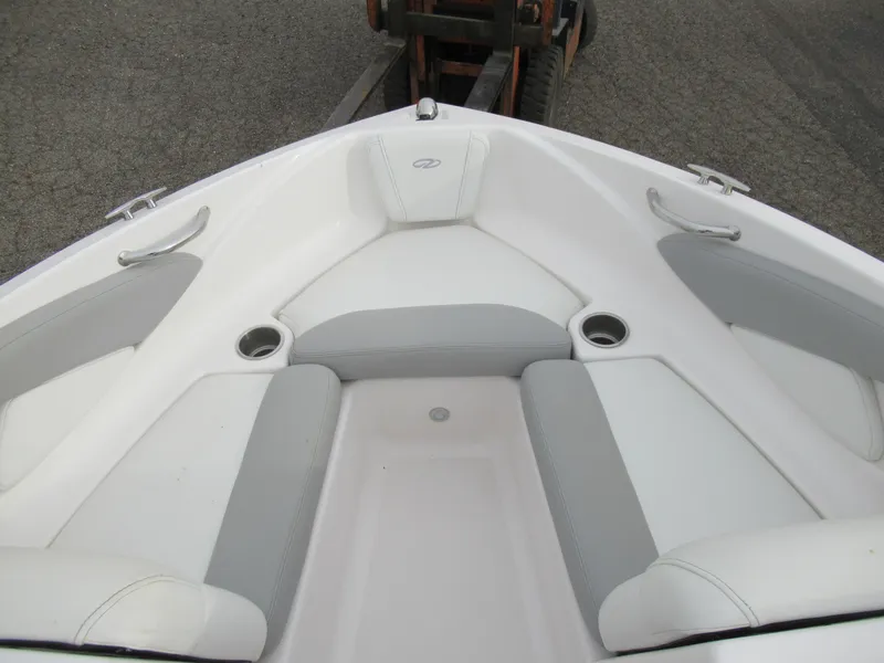 Slide: The Image of 2019 Regal 1900 ES Bowrider boat interior with white and gray seating. - 16