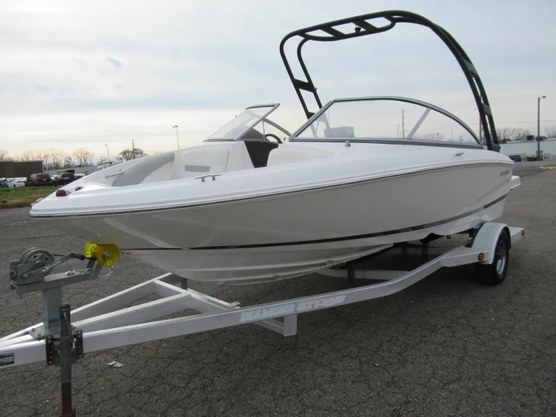 Slide: The Image of 2019 Regal 1900 ES Bowrider on trailer, white exterior, parked outdoors. - 5