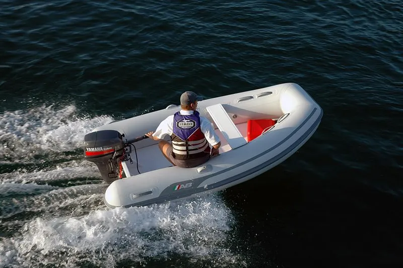 Slide: The Image of 2023 AB Inflatables 9.5 Lammina AL boat cruising on water. - 2