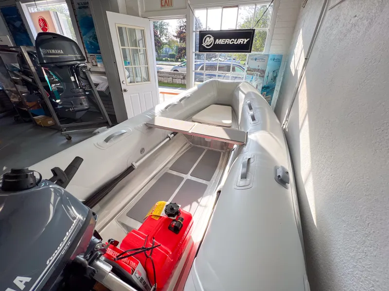 Slide: The Image of 2023 AB Inflatables 9.5 Lammina AL boat displayed in showroom with Yamaha motor. - 5