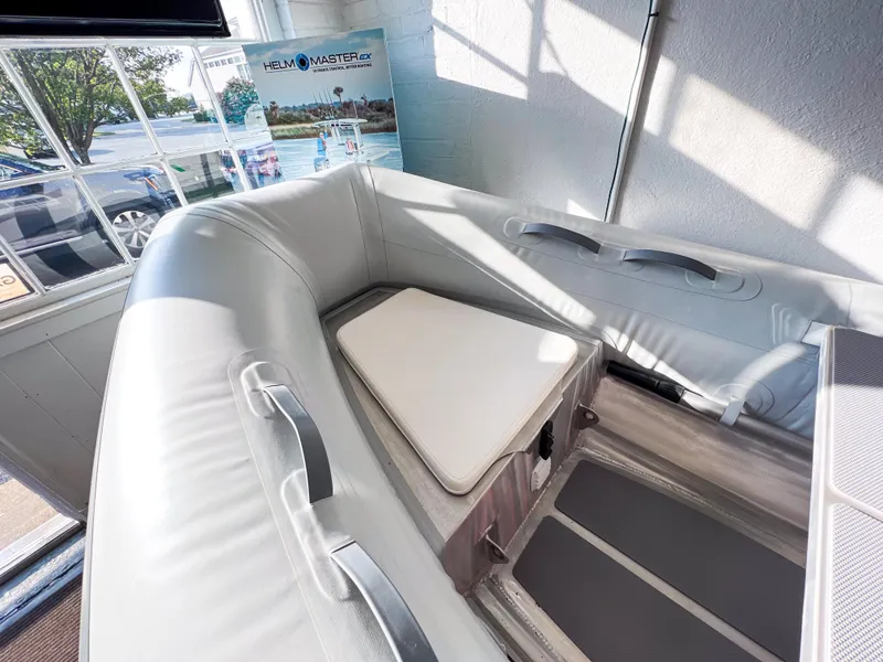 Slide: The Image of 2023 AB Inflatables 9.5 Lammina AL boat interior with seating, displayed indoors. - 7