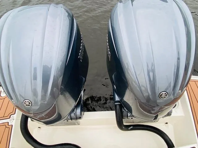 Slide: The Image of Twin Yamaha outboard engines on a 2021 Cobia 330 Dual Console boat. - 24