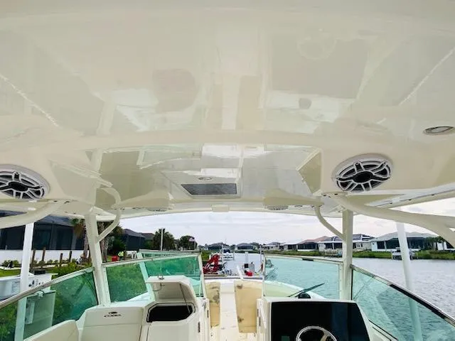 Slide: The Image of 2021 Cobia 330 Dual Console boat interior with helm and seating area. - 28