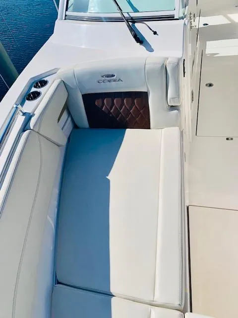 Slide: The Image of 2021 Cobia 330 Dual Console boat interior with cushioned seating. - 37