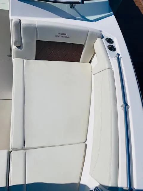 Slide: The Image of 2021 Cobia 330 Dual Console boat with white cushioned seating. - 40