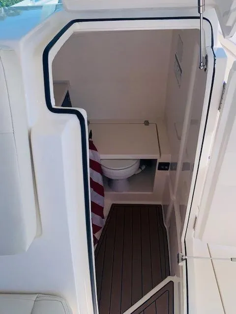Slide: The Image of 2021 Cobia 330 Dual Console boat interior with a compact bathroom. - 43