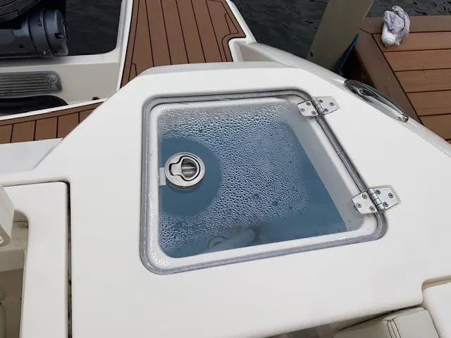 Slide: The Image of 2021 Cobia 330 Dual Console livewell with water and bubbles. - 49