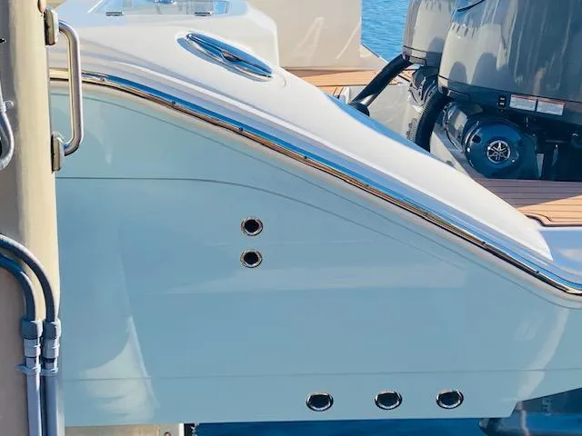 Slide: The Image of 2021 Cobia 330 Dual Console boat with sleek design and powerful engines. - 6