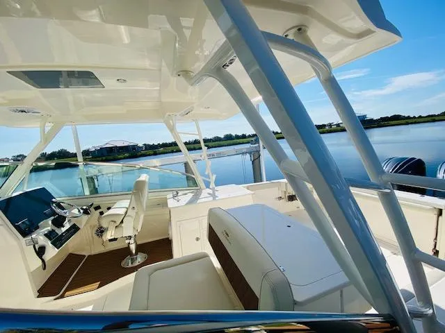 Slide: The Image of 2021 Cobia 330 Dual Console boat interior with scenic water view. - 9