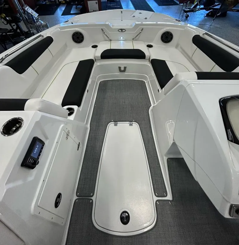 Slide: The Image of 2023 Tahoe 1950 boat interior with white and black seating, spacious layout. - 2