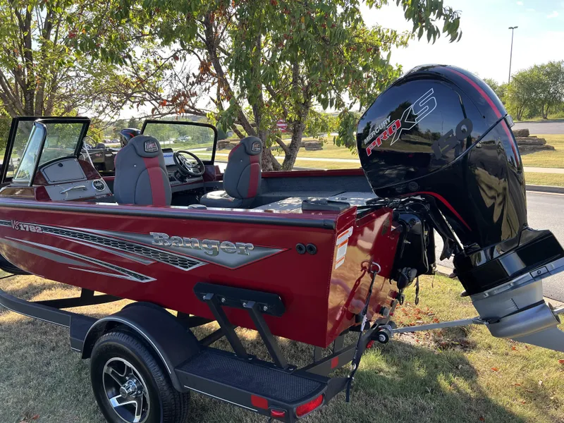 Slide: The Image of 2023 Ranger VS1782SC Angler boat with Mercury engine, parked on grass. - 4
