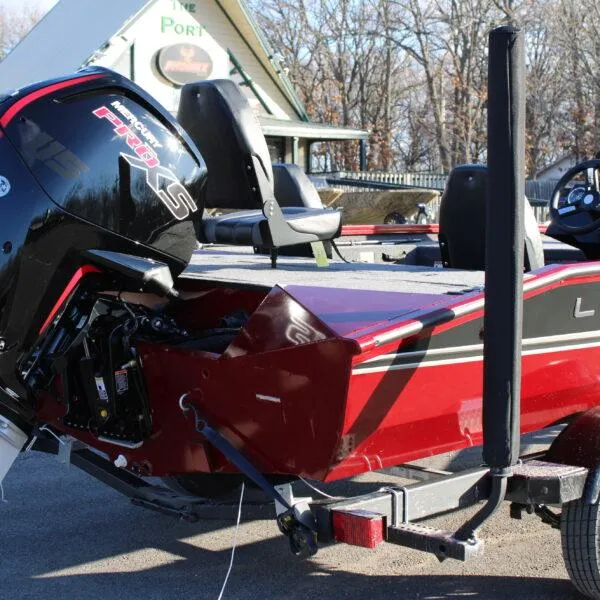 Slide: The Image of 2023 Lowe ST188 boat with Mercury Pro XS engine, red and black design, parked on trailer. - 3