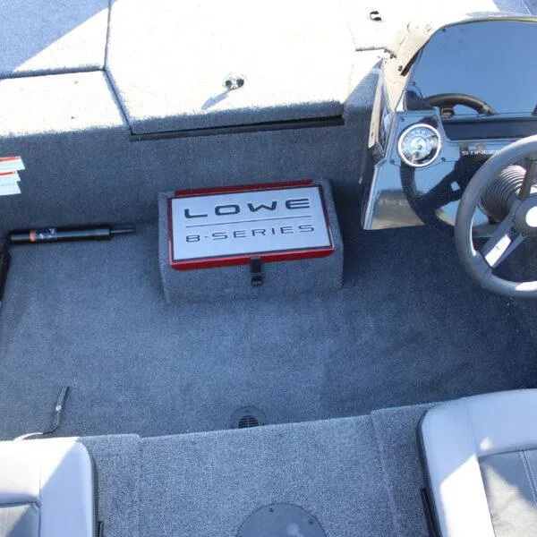 Slide: The Image of Interior of 2023 Lowe ST188 boat showing steering wheel and Lowe B-Series logo. - 5