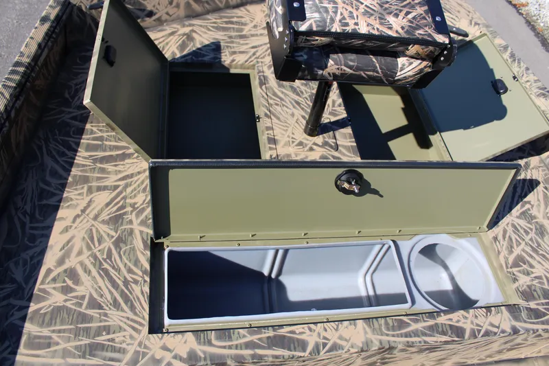 Slide: The Image of 2023 Lowe RX 2070 SC boat with open storage compartments and camouflage pattern. - 5