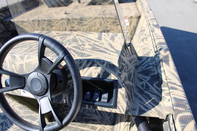 Slide: The Image of 2023 Lowe RX 2070 SC boat interior with camo design and steering wheel. - 7
