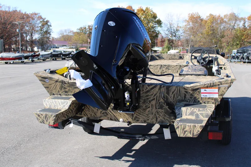 Slide: The Image of 2023 Lowe RX 2070 SC boat with camouflage design and outboard motor. - 9