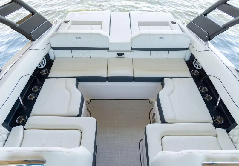 Slide: The Image of 2025 Regal LS2 boat interior with luxurious white seating and cup holders. - 13