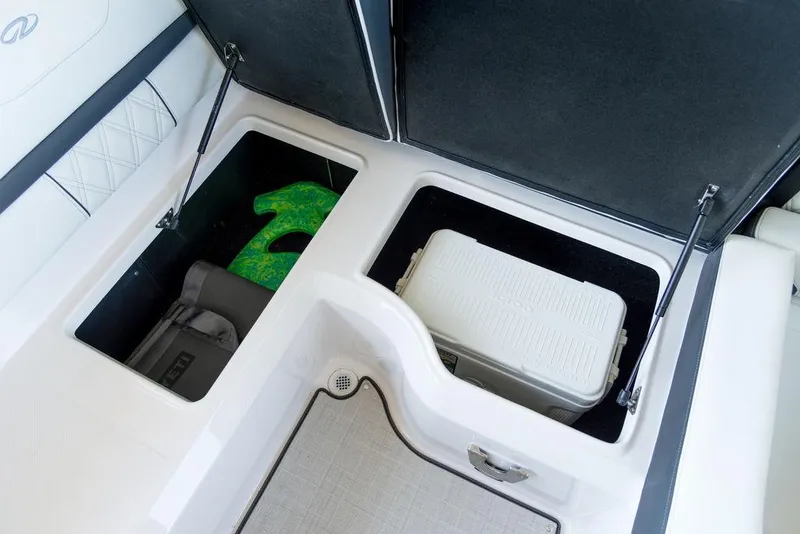 Slide: The Image of 2025 Regal LS2 boat storage compartments with cooler and gear. - 15