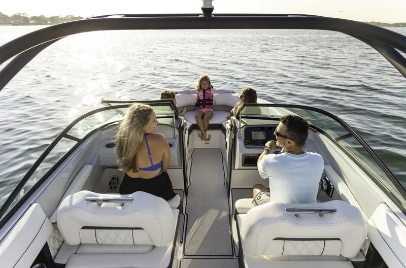 Slide: The Image of 2025 Regal LS2 boat with passengers enjoying a sunny day on the water. - 4