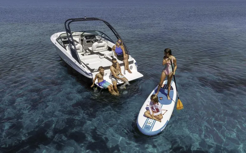 Slide: The Image of Family enjoying water activities near a 2025 Regal LS2 boat. - 5