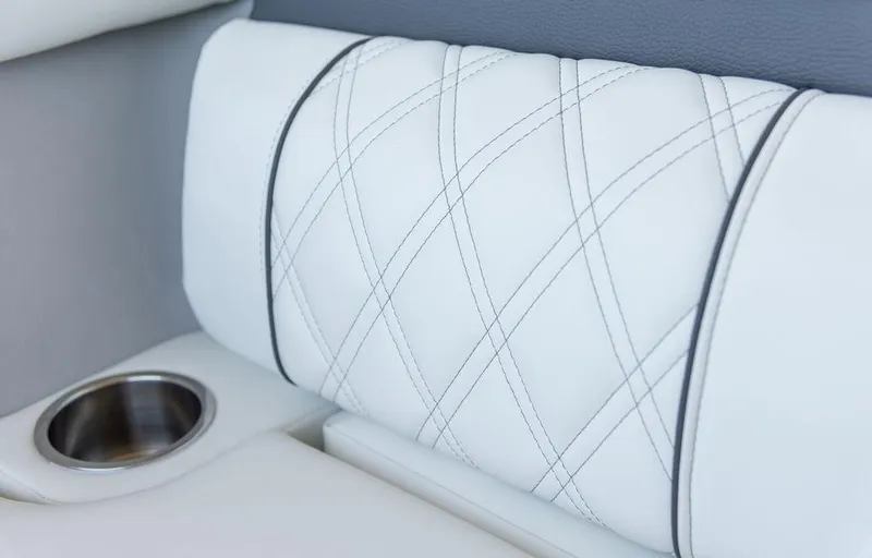 Slide: The Image of 2025 Regal LS2 boat interior with white diamond-stitched upholstery and stainless steel cup holder. - 9